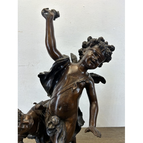 573 - A late 19th/early 20th century cast bronze blindfolded Cupid with young girl statue after Edme Bouch... 