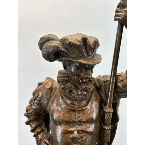 574 - A late 19th/early 20th century cast spelter cavalier statue on circular wooden base - approx. 75cm h... 