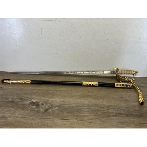 580 - A reproduction Imperial Sword Co. of London Naval Officer's dress sword with black leather and brass... 