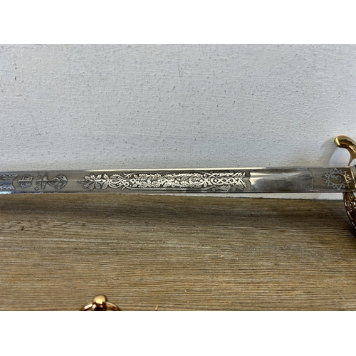 580 - A reproduction Imperial Sword Co. of London Naval Officer's dress sword with black leather and brass... 