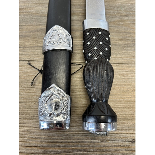 581 - A reproduction Ancient Warrior Scott's Guards Piper's dirk with black leather sheath