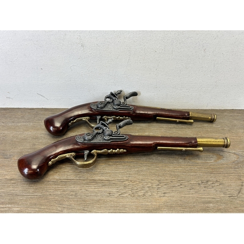 583 - A pair of reproduction duelling flintlock pistols