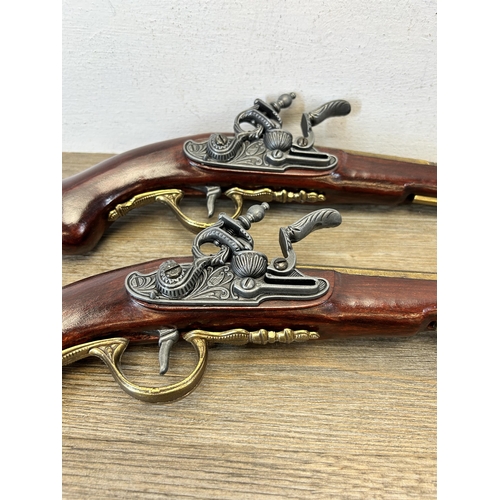 583 - A pair of reproduction duelling flintlock pistols