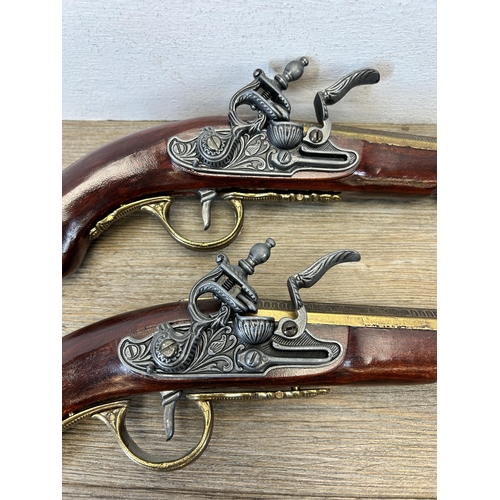 583 - A pair of reproduction duelling flintlock pistols