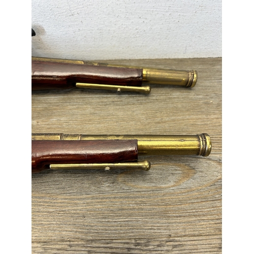 583 - A pair of reproduction duelling flintlock pistols