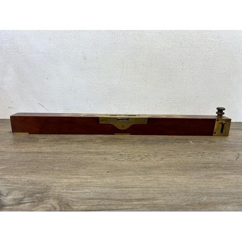 594 - A 19th century brass and mahogany spirit level - approx. 45cm long