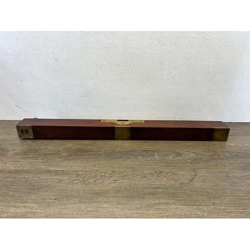 594 - A 19th century brass and mahogany spirit level - approx. 45cm long