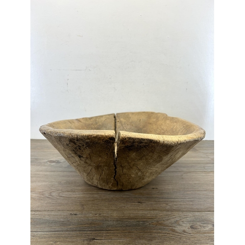 597 - A 19th century carved elm dough bowl - approx. 16cm high x 66cm long x 40cm wide