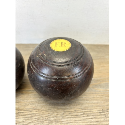 598 - Two antique lignum vitae Crown Green bowls