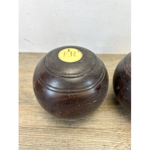 598 - Two antique lignum vitae Crown Green bowls