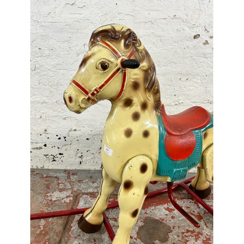 473 - A vintage tinplate rocking horse