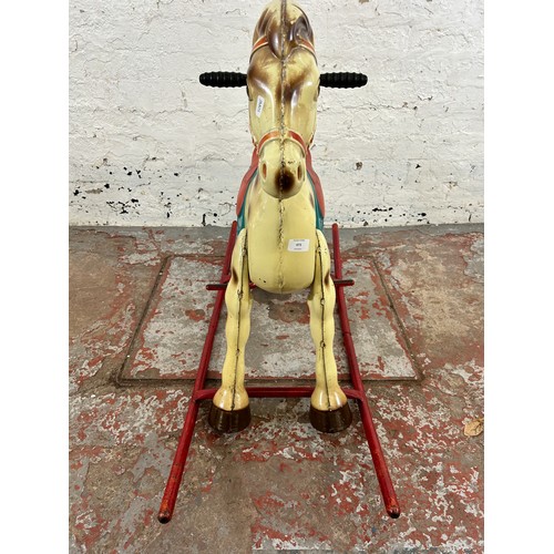 473 - A vintage tinplate rocking horse