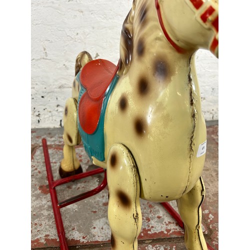 473 - A vintage tinplate rocking horse