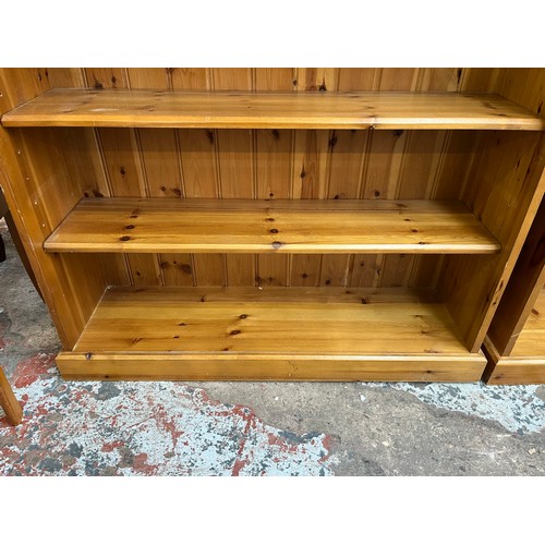 49 - A modern pine three tier bookcase - approx. 99cm high x 103cm wide x 29cm deep