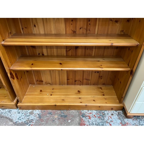 50 - A modern pine three tier bookcase - approx. 99cm high x 103cm wide x 29cm deep