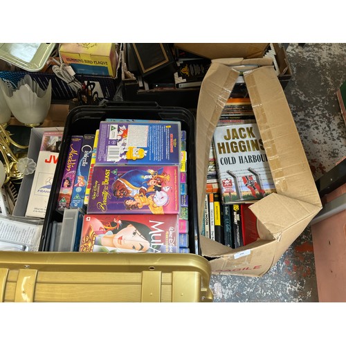 998 - Seven boxes containing Disney VHS tapes, brass horse figurine, books, artificial Christmas tree etc.