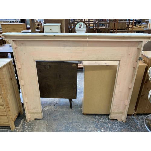 9 - A Victorian style white painted wooden fire surround - approx. 130cm high x 168cm wide x 20cm deep