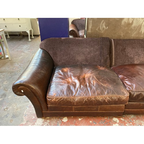 35 - A brown leather and fabric upholstered four seater sofa - approx. 79cm high x 252cm x 106cm