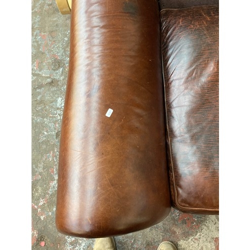 36 - A brown leather and fabric upholstered four seater sofa - approx. 79cm high x 252cm long x 106cm dee... 