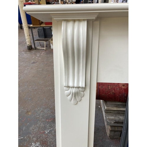 43 - A Victorian style white painted MDF fire surround - approx. 131cm high x 155cm wide x 23cm deep