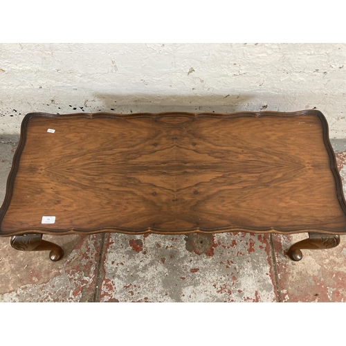 52 - A walnut serpentine rectangular coffee table on cabriole supports