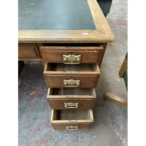 53 - An early 20th century oak pedestal writing desk - approx. 77cm high x 121cm wide x 66cm deep