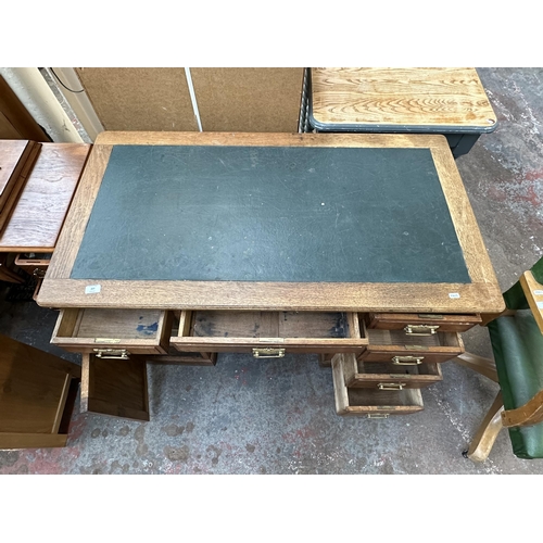 53 - An early 20th century oak pedestal writing desk - approx. 77cm high x 121cm wide x 66cm deep