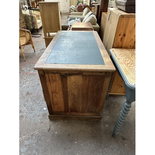 53 - An early 20th century oak pedestal writing desk - approx. 77cm high x 121cm wide x 66cm deep