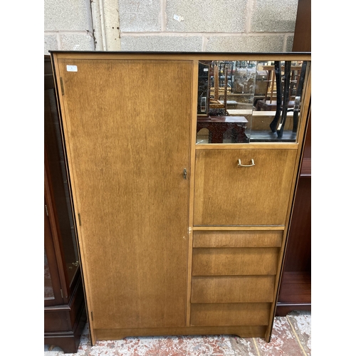 64 - A mid 20th century oak gentleman's wardrobe - approx. 152cm high x 102cm wide x 47cm deep