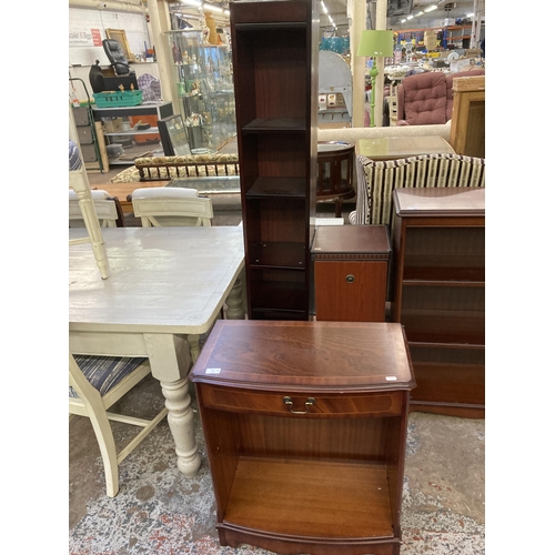 100 - Three pieces of furniture, one mahogany two tier open bookcase, one mahogany effect revolving CD cab... 