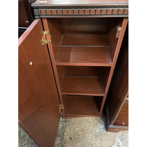 100 - Three pieces of furniture, one mahogany two tier open bookcase, one mahogany effect revolving CD cab... 