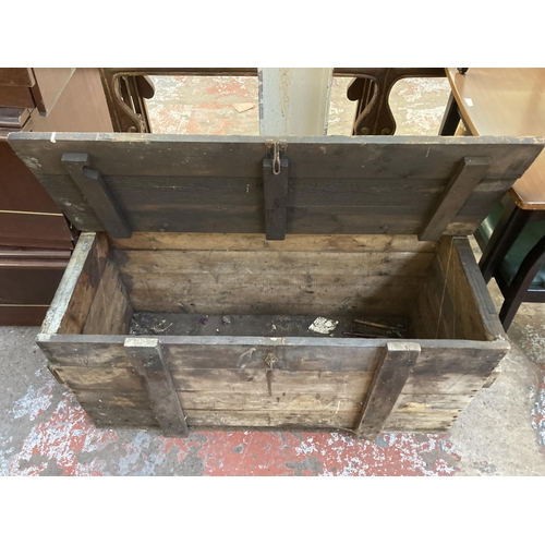 134 - An early 20th century pine tool box - approx. 54cm high x 109cm wide x 48cm deep