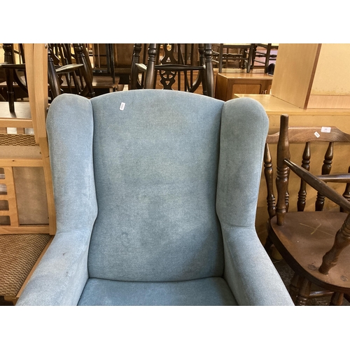 195 - A modern fabric upholstered wingback armchair