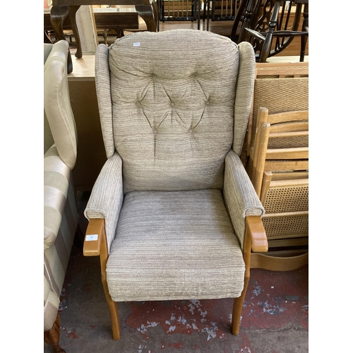 197 - A modern beech and fabric upholstered wingback armchair