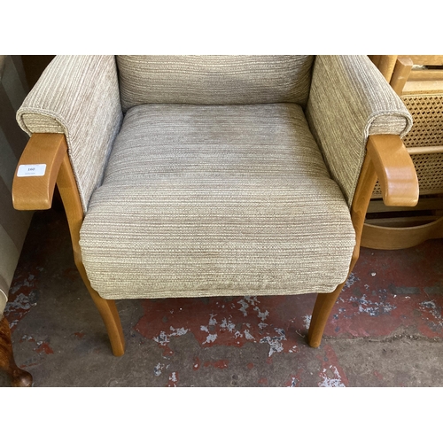 197 - A modern beech and fabric upholstered wingback armchair