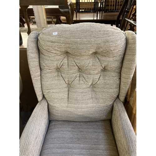 197 - A modern beech and fabric upholstered wingback armchair