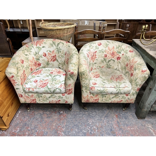 219 - A pair of Victorian style floral fabric upholstered armchairs with turned wooden supports and brass ... 