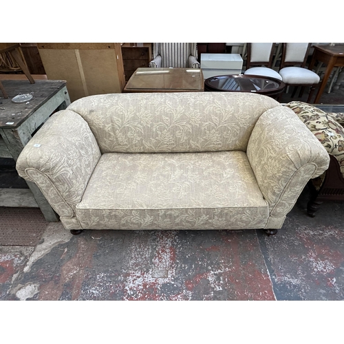 225 - A late 19th/early 20th century floral fabric upholstered double drop arm sofa