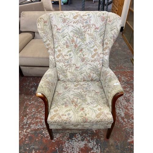 240 - A mid 20th century Parker Knoll PK750 beech and floral fabric upholstered wingback armchair