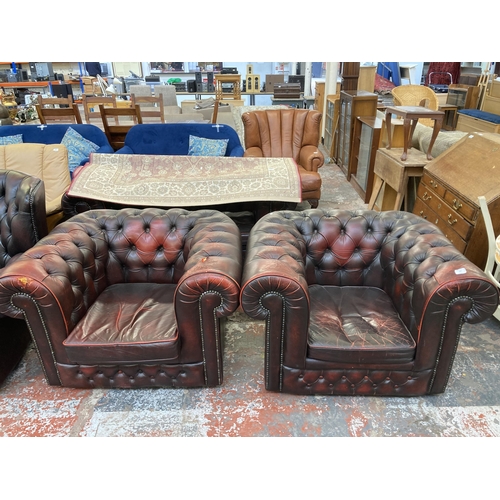 243 - A pair of oxblood leather Chesterfield club chairs