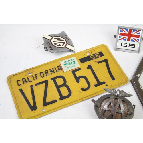 1125 - Five items of automobilia to include car badges, license plate etc.