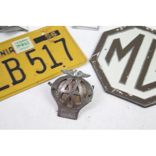 1125 - Five items of automobilia to include car badges, license plate etc.