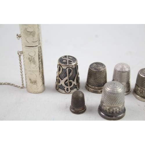 2454E - Eight pieces of .925 sterling silver, seven thimbles and one needle case - approx. gross weight 40g