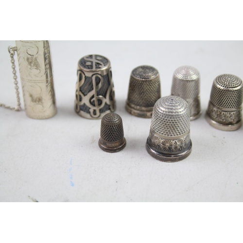 2454E - Eight pieces of .925 sterling silver, seven thimbles and one needle case - approx. gross weight 40g