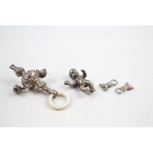 2454H - Four hallmarked sterling silver items to include baby rattles etc. - approx. gross weight 82g