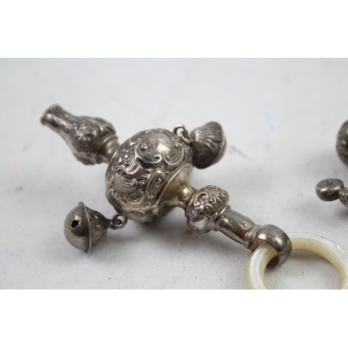 2454H - Four hallmarked sterling silver items to include baby rattles etc. - approx. gross weight 82g