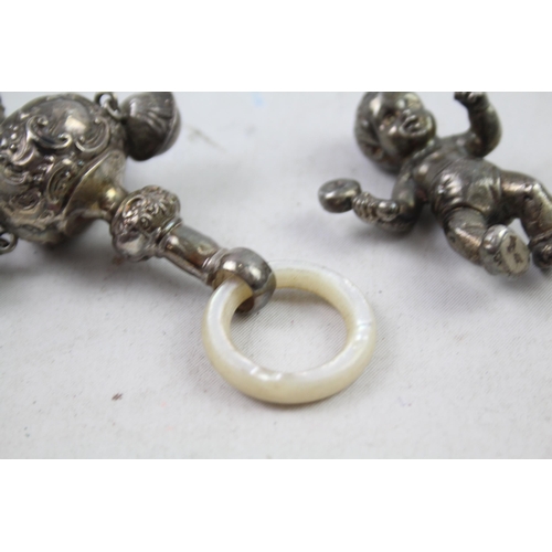 2454H - Four hallmarked sterling silver items to include baby rattles etc. - approx. gross weight 82g