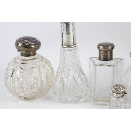 2468 - Nine .925 sterling silver topped and cut glass vanity bottles