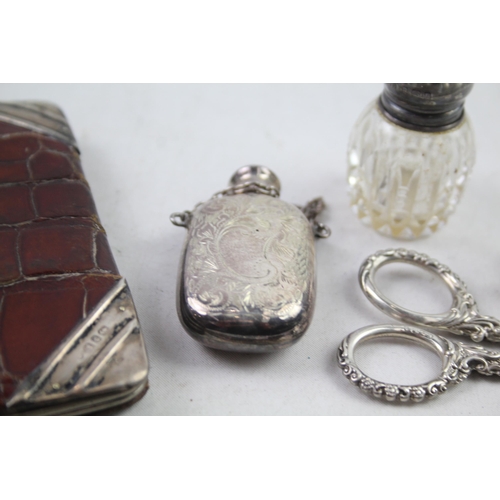 2486 - Eight .925 sterling silver vanity items to include scent bottles, purse etc.