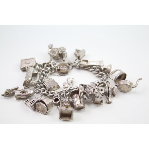 2348 - A silver charm bracelet with assorted charms - approx. gross weight 103g